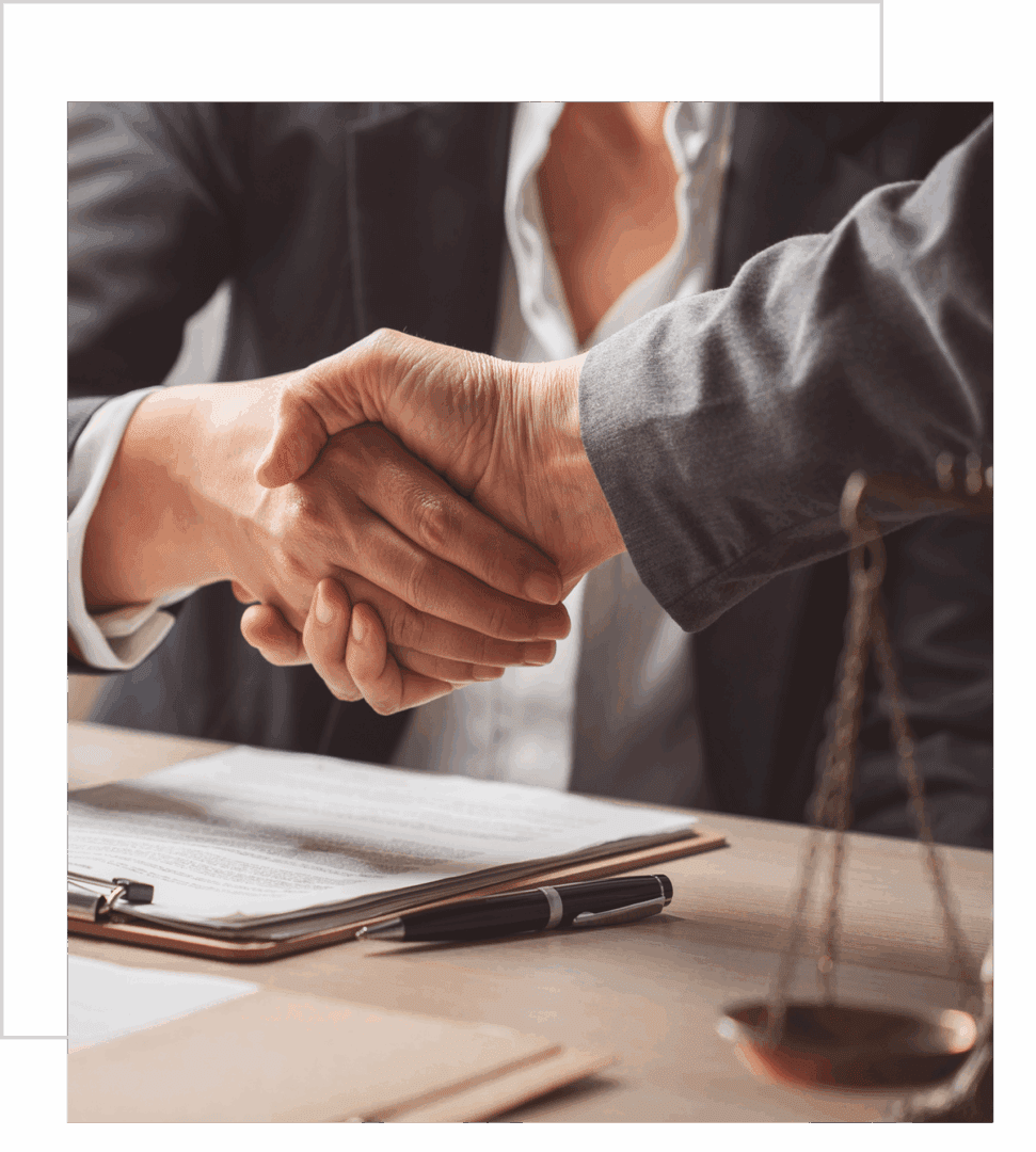 Business handshake over legal documents