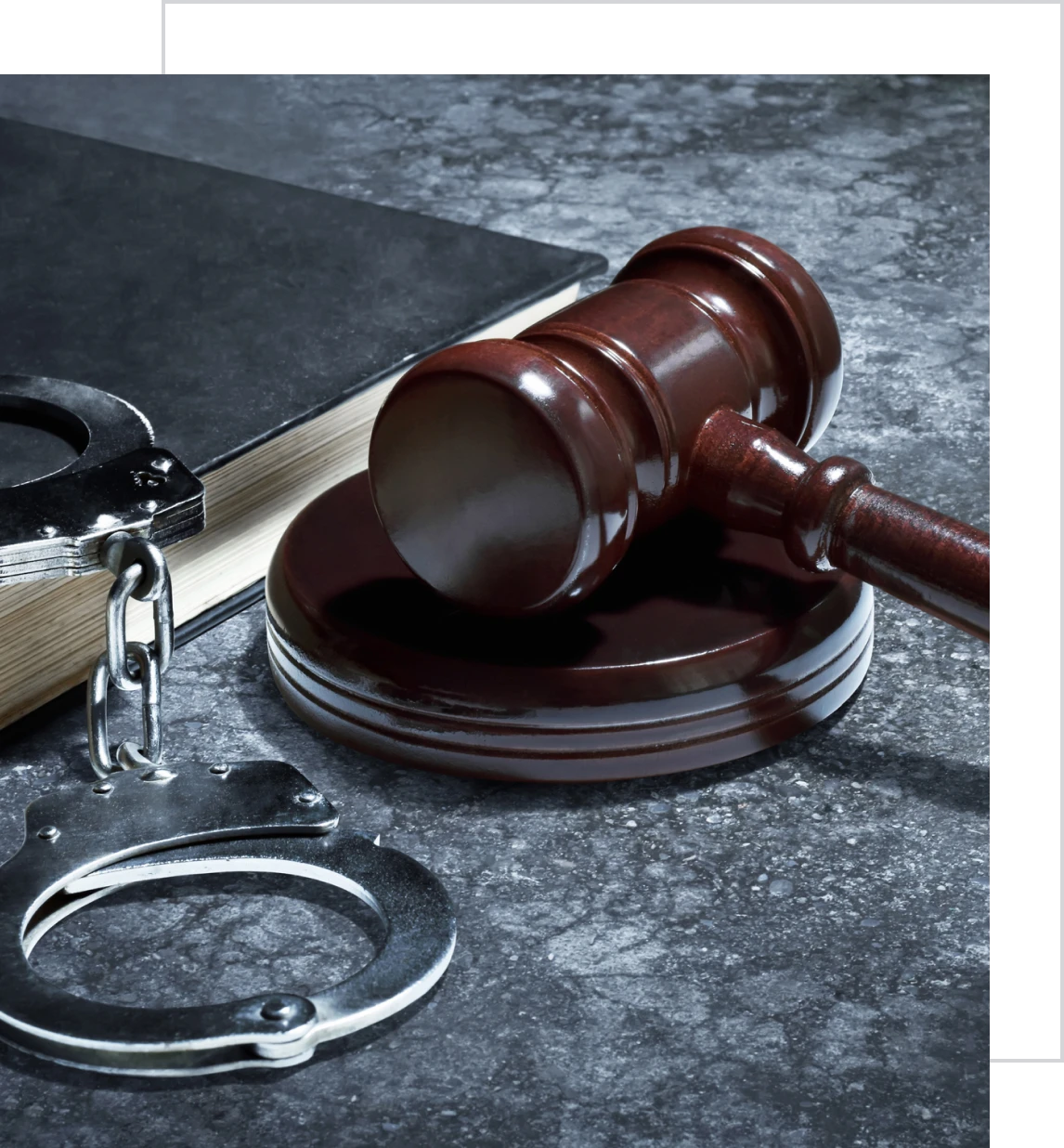 Gavel and handcuffs on table