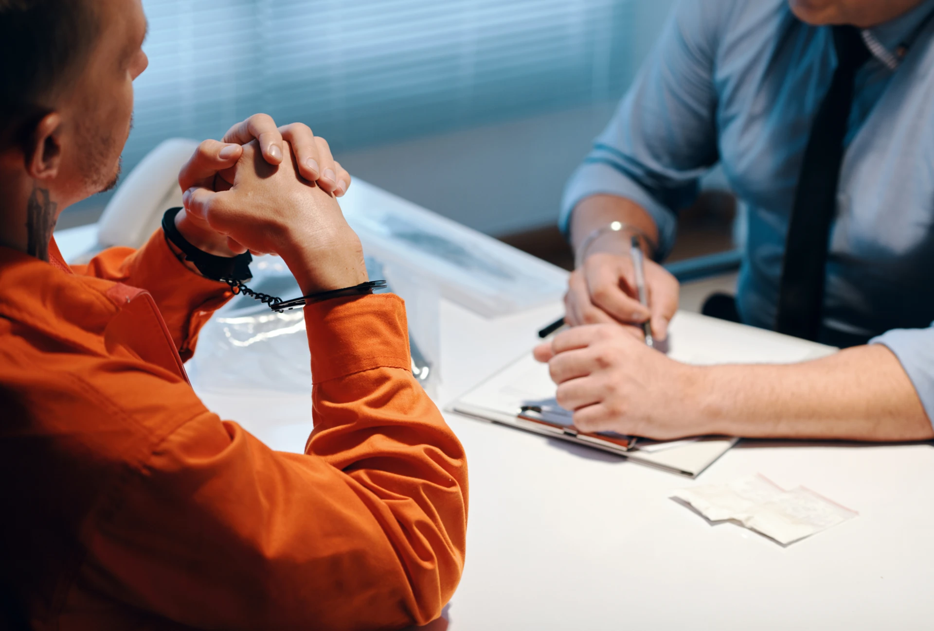 Interrogation scene at a table.
