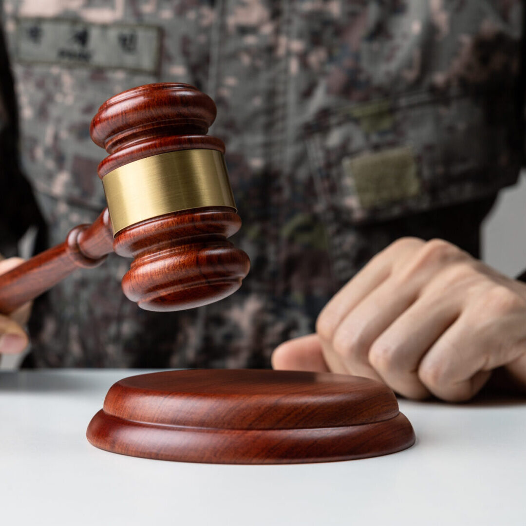 Military uniform with gavel on table