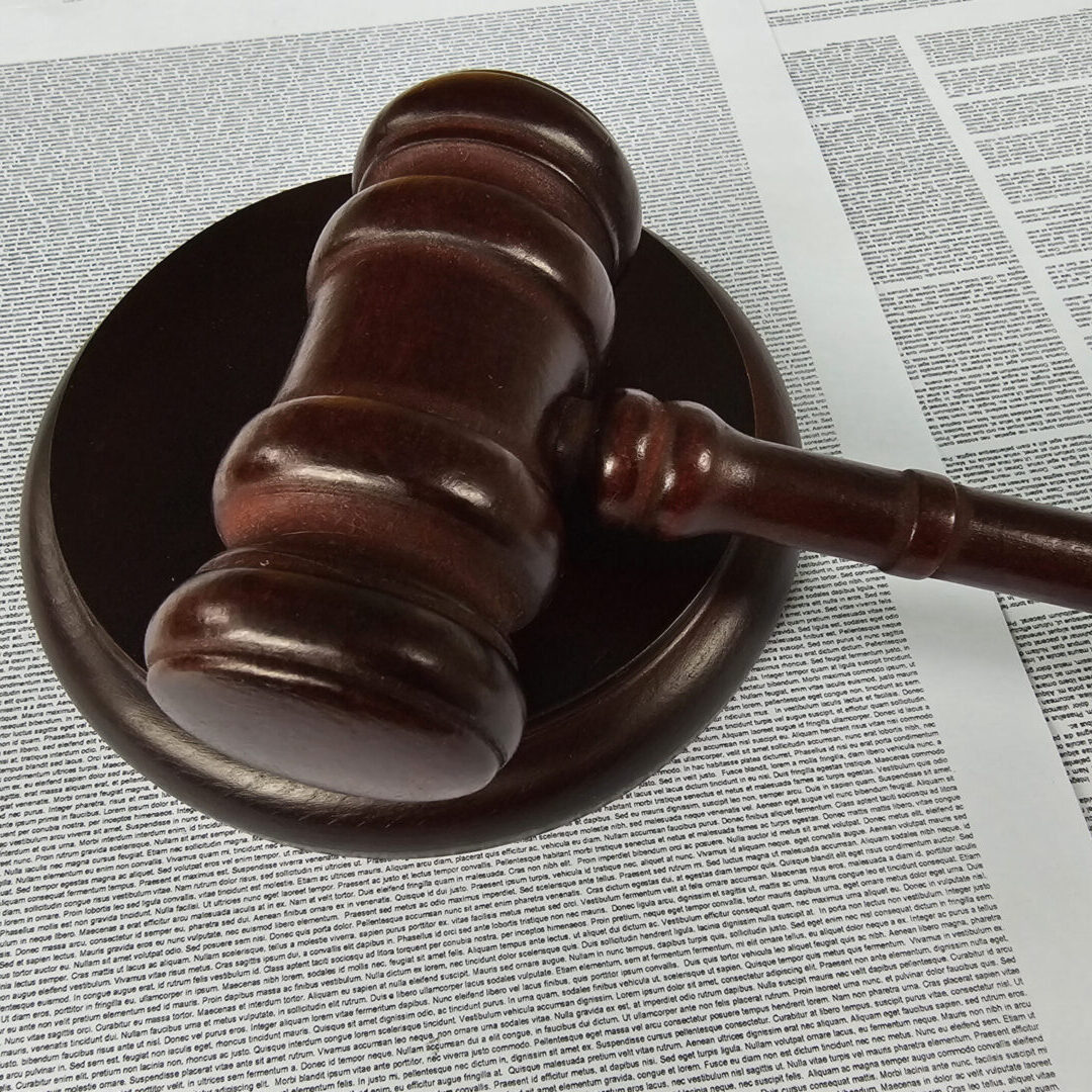 Judge's gavel atop legal text